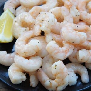 Air fryer shrimp on a plate with lemon