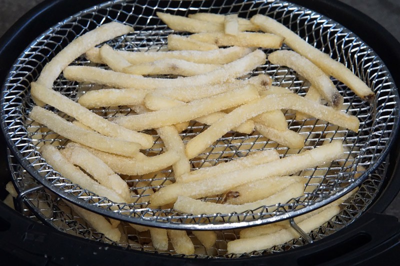 uncooked french fries in an air fryer