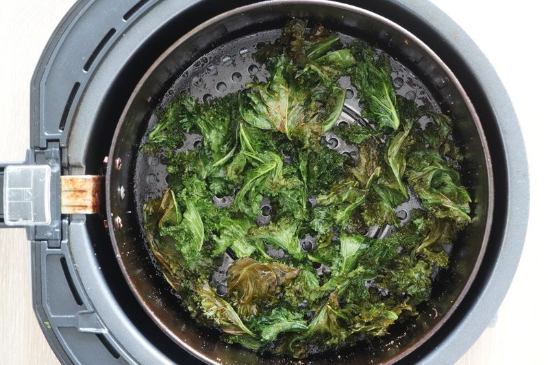 Cooked kale in the air fryer basket