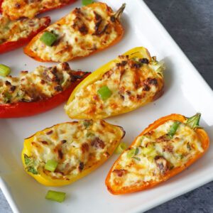 baked cream cheese stuffed peppers on a plate