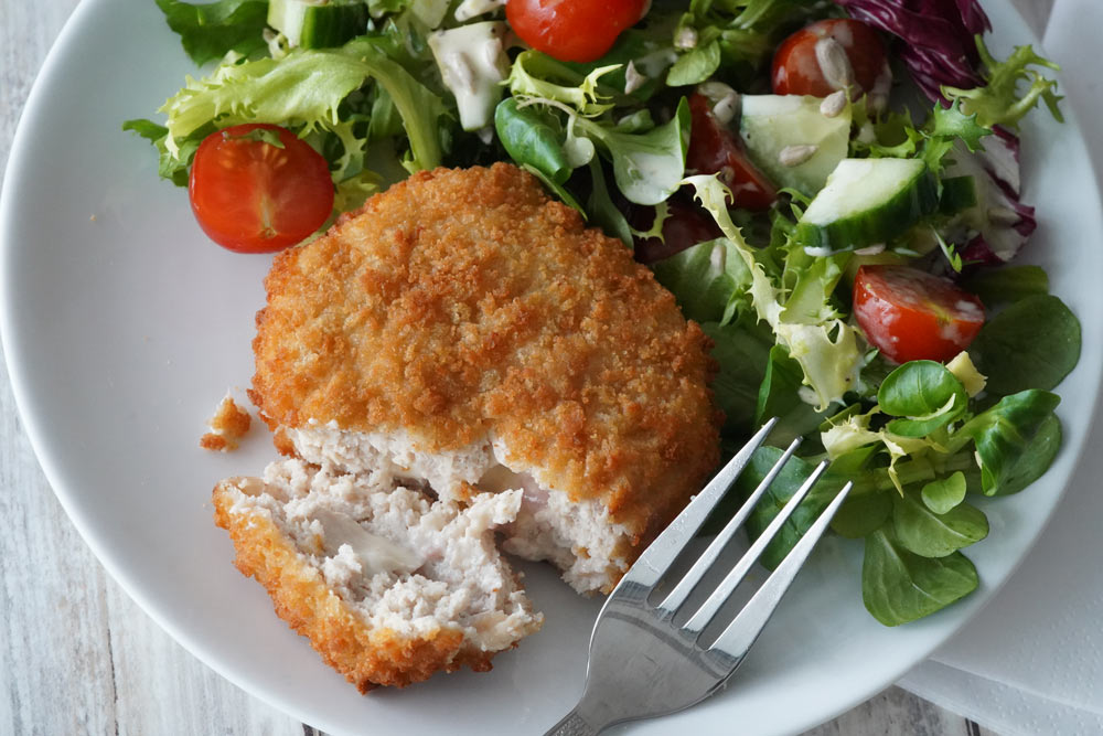 Chicken Kiev on a plate with salad