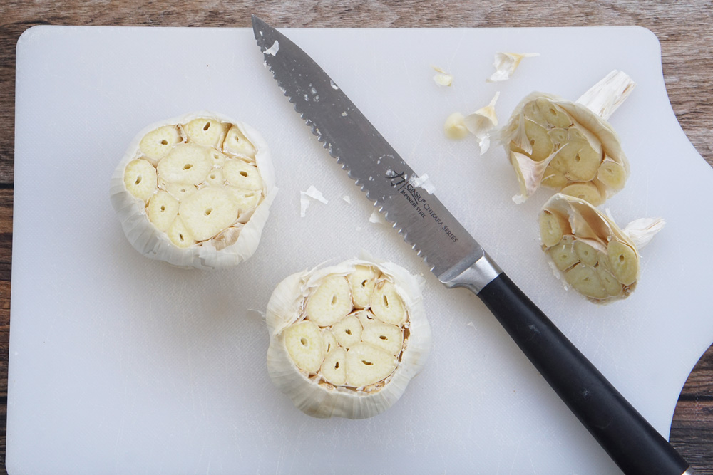 Cutting the tops off of the garlic bulbs