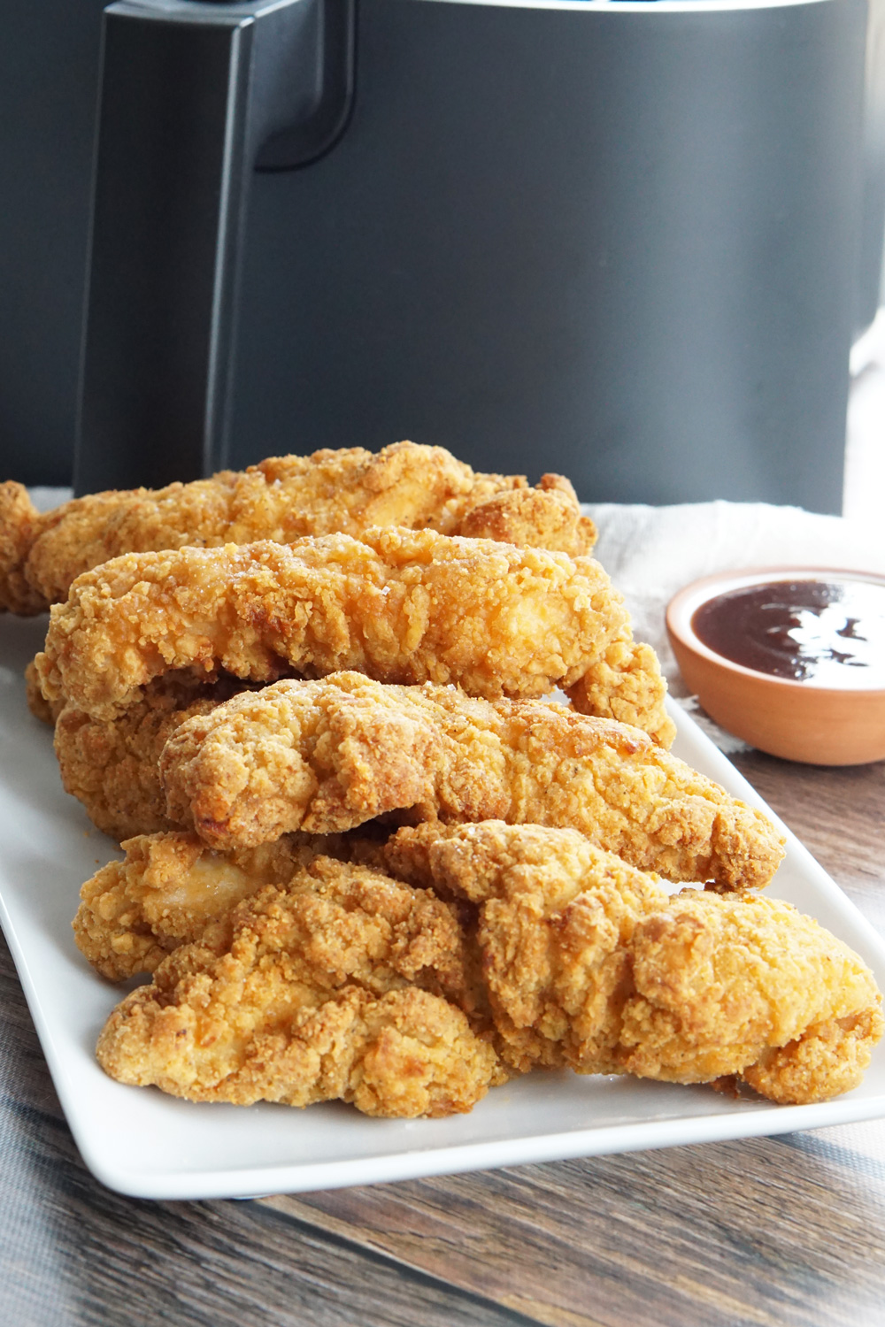 Chicken tenders on a platter with dipping sauce