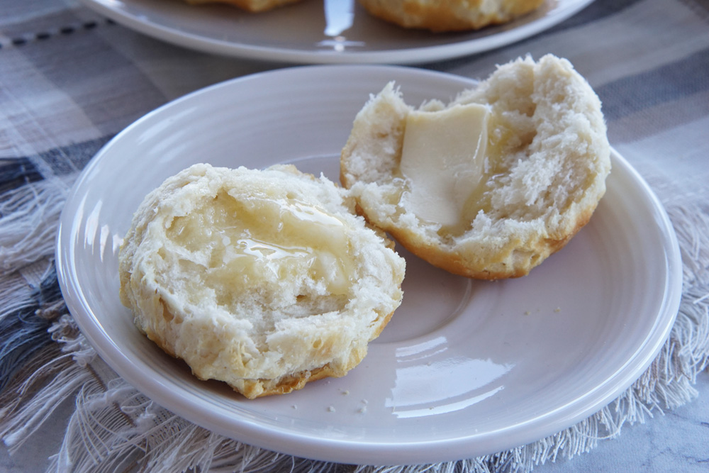 a biscuit cut in half with butter