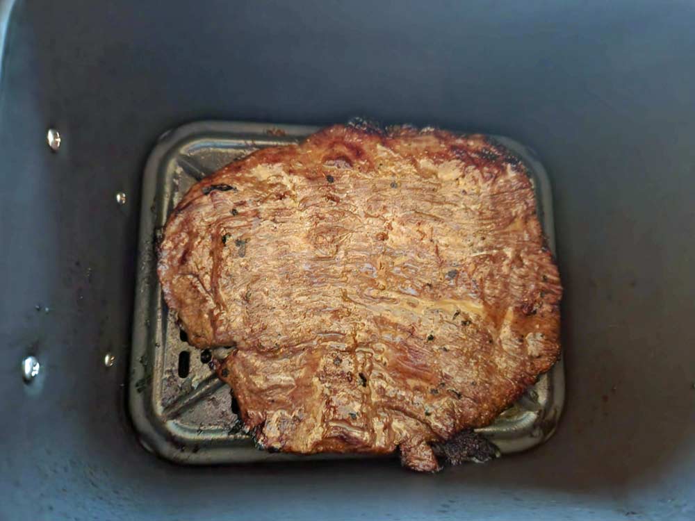 cooked flank steak in the air fryer basket