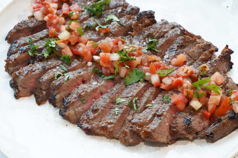Air fryer flank steak with salsa on top