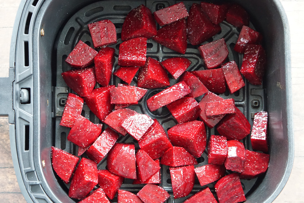 Uncooked beets in the air fryer basket