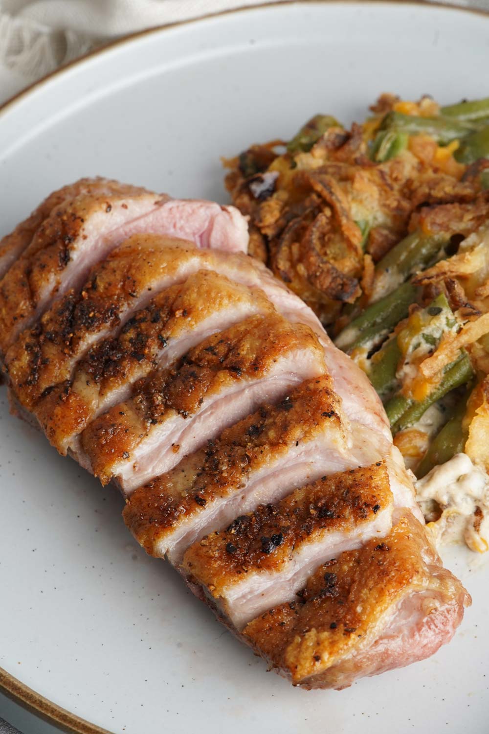 Sliced duck breast with green bean casserole