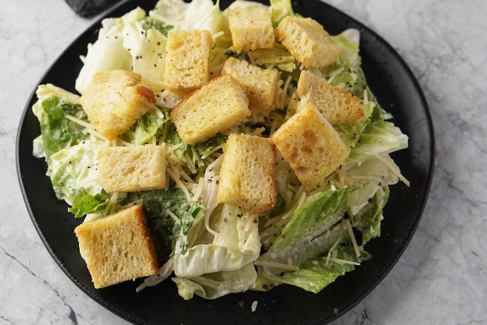 air fryer croutons on top of a Caesar salad